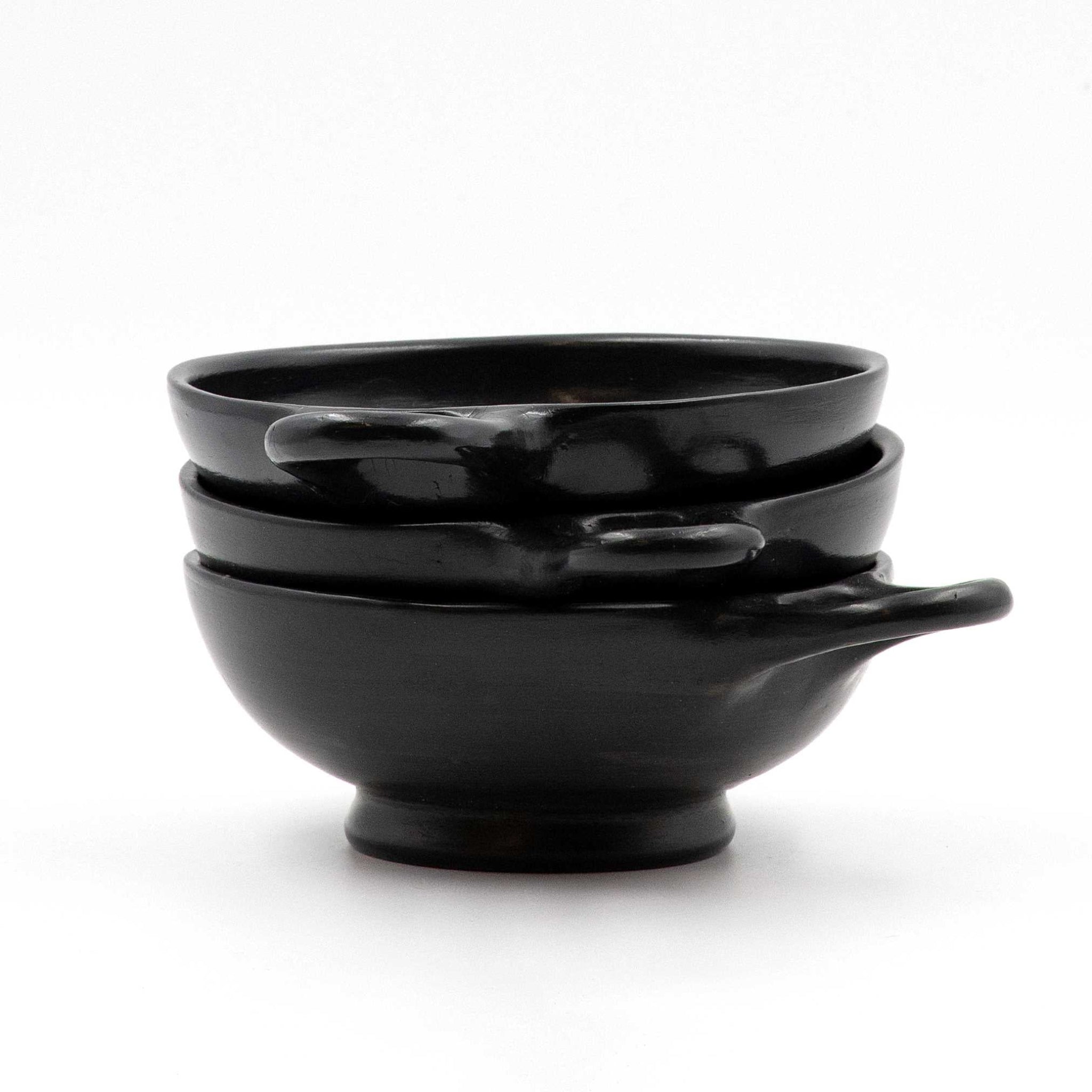A black glazed shallow one-handle skyphos.