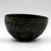 A Cypriot dark incised bowl with a geometric pattern, displayed against a white background.