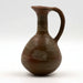 A dark polished ceramic flask with a handle, featuring a geometric pattern.