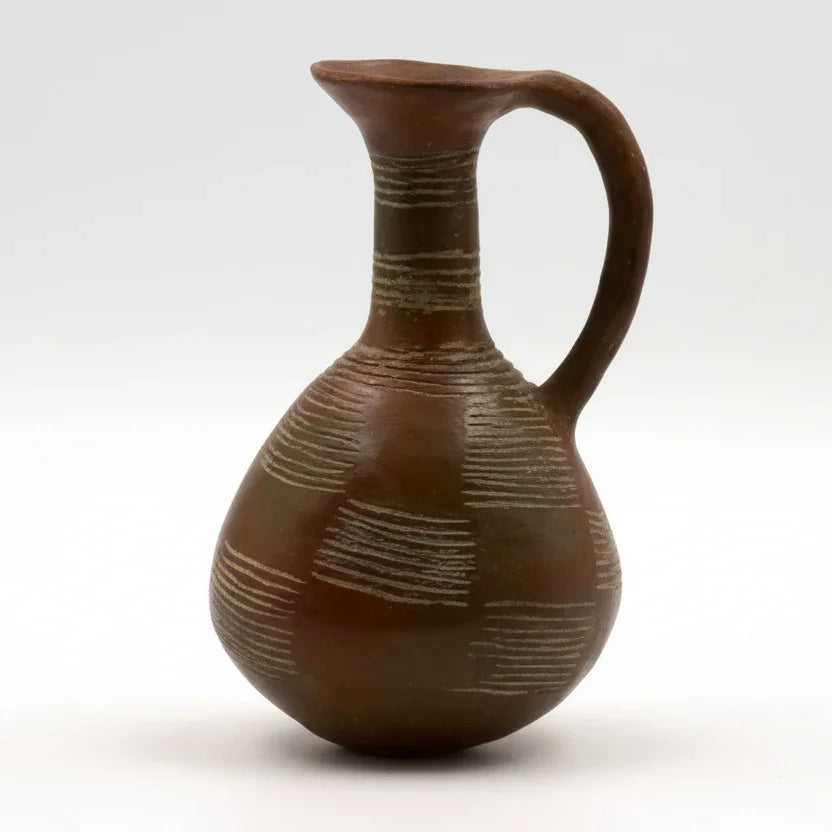 A dark polished ceramic flask with a handle, featuring a geometric pattern.