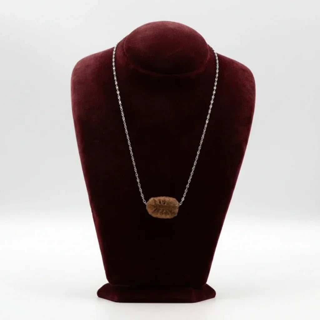 Handcrafted ceramic pendant necklace with silver chain on a velvet display bust