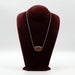 Handcrafted ceramic pendant necklace with silver chain on a velvet display bust