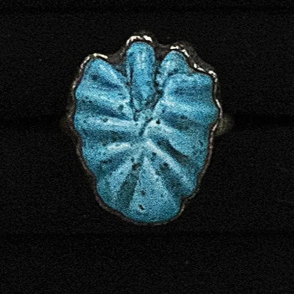 Blue ceramic leaf-shaped object on a black background