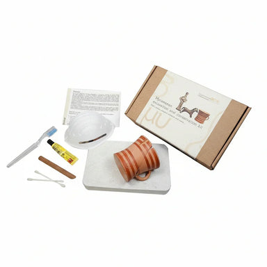 Mycenaean ceramic excavation and conservation kit with pottery, tools and box on white background