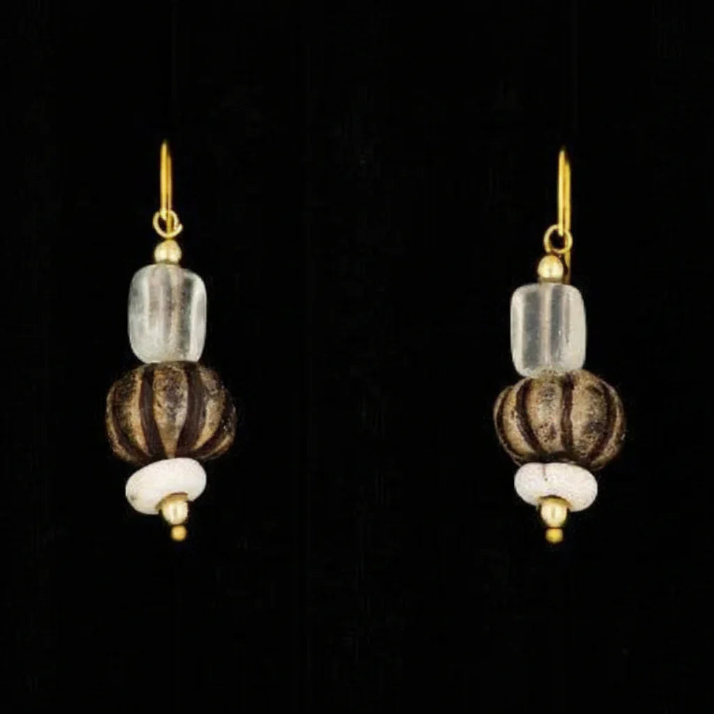 A pair of drop earrings featuring glazed beads and a glass drop design with gold accents on a black background.