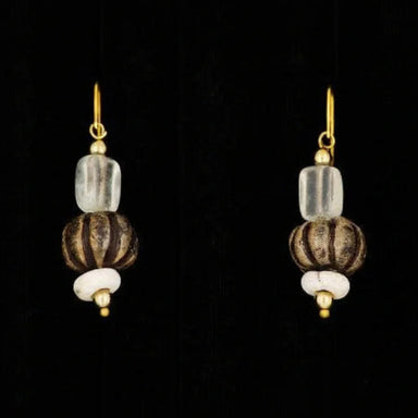 A pair of drop earrings featuring glazed beads and a glass drop design with gold accents on a black background.