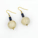 A pair of glazed bead and lapis drop earrings with gold-colored clasps on a white background.