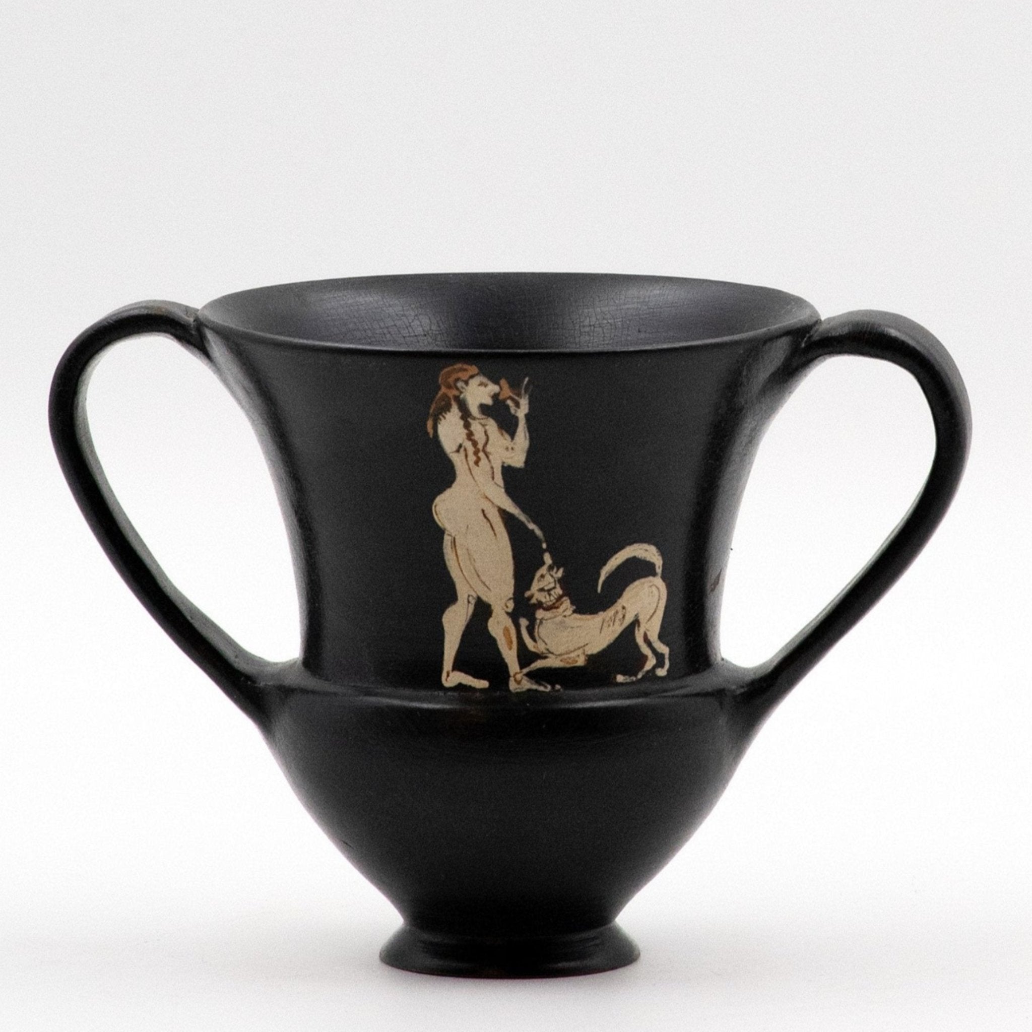 A black kantharos with a white decoration depicting a figure with a dog on one side.