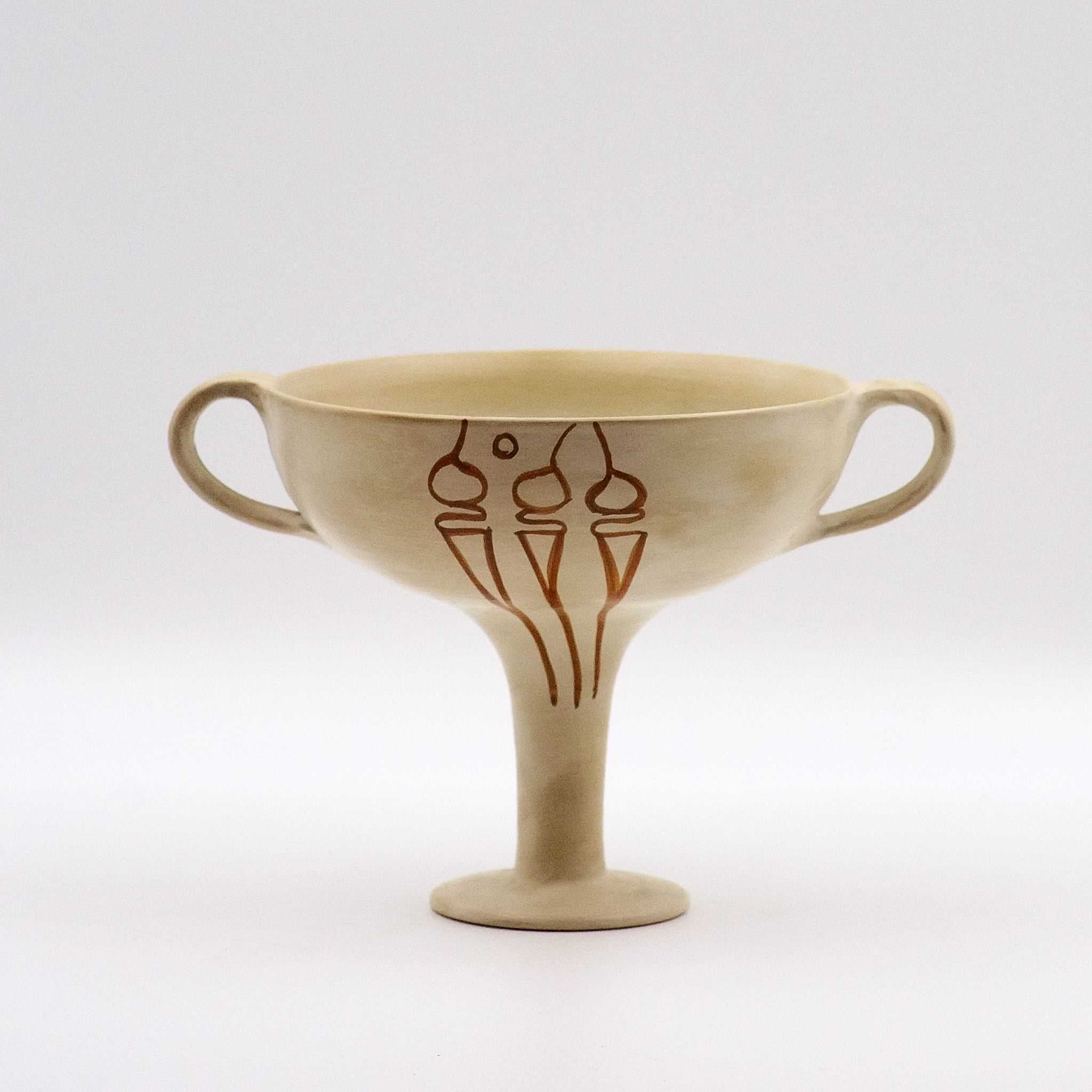 A beige ceramic Mycenaean Kylix with stylized sea shell motifs.