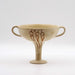 A beige ceramic Mycenaean Kylix with stylized sea shell motifs.
