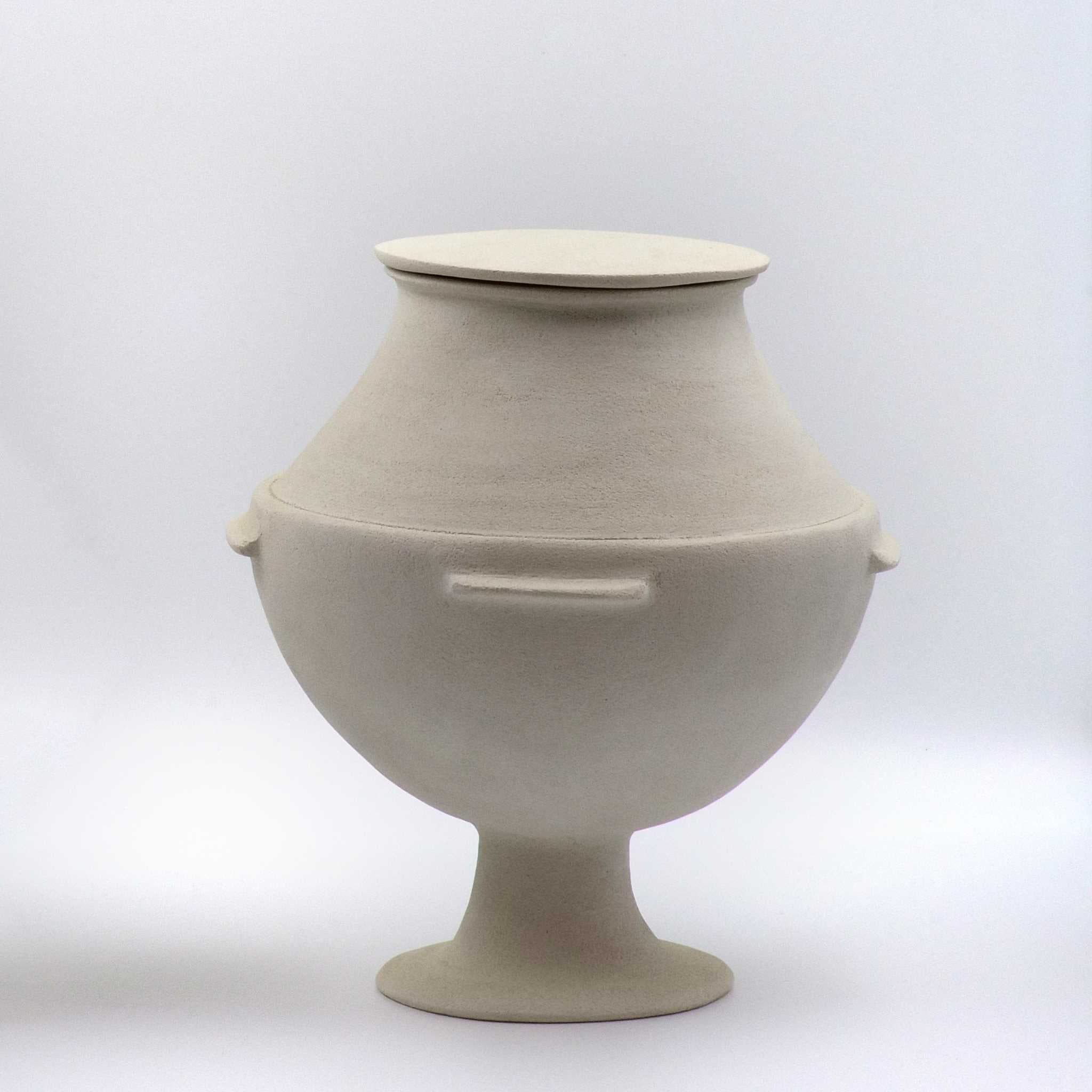 A beige, hand-built ceramic storage jar with a lid and a tall cylindrical foot, inspired by ancient Cycladic marble vases.