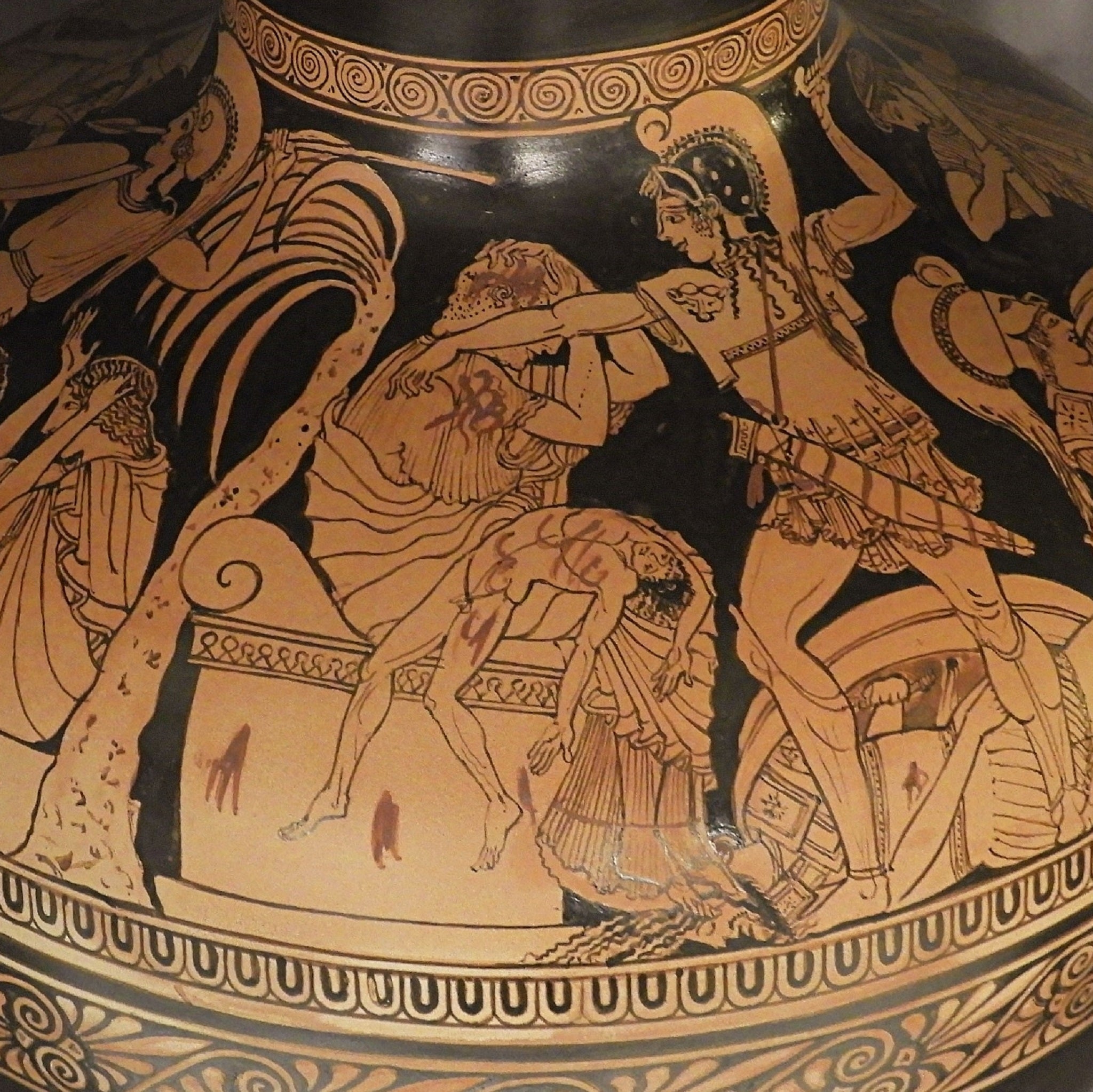 A decorated ceramic vase depicting a scene from the Sack of Troy, with figures such as Aeneas and Cassandra.