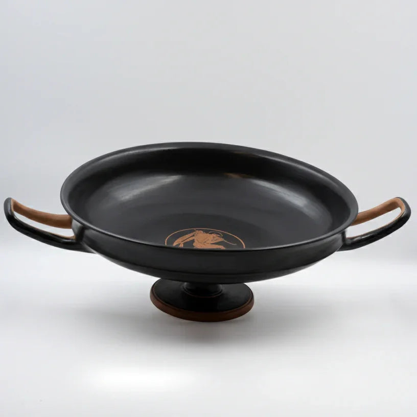 A black ceramic decorative bowl with double handles, isolated on a white background.