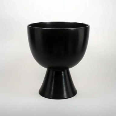 A black round pedestal bowl on a white background
