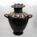 Black ceramic urn with gold decorative patterns on a white background