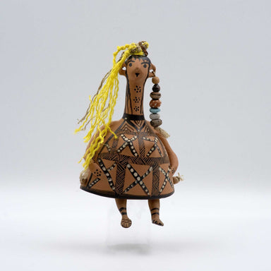 Ceramic figurine with decorative patterns on a white background