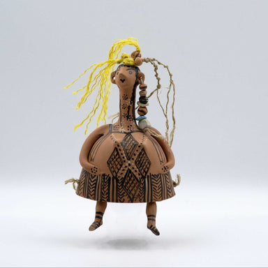 Ceramic figurine with intricate patterns on a plain background